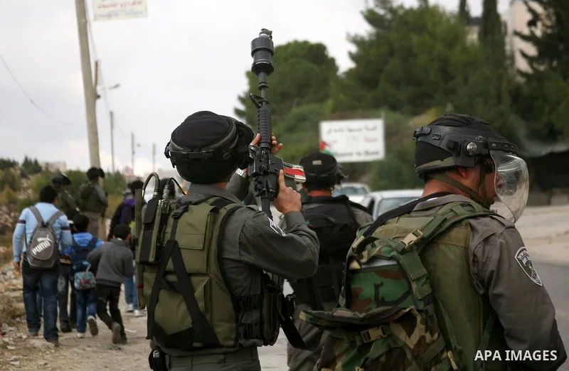 Palestinian students clash with Israeli soldiers during a demonstration in near the West Bank city of Hebron in Fawwar camp on Nov. 14, 2012, to mark the 24th anniversary of the Palestinian Independence Day. Palestinians...