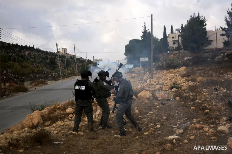 Palestinian students clash with Israeli soldiers during a demonstration in near the West Bank city of Hebron in Fawwar camp on Nov. 14, 2012, to mark the 24th anniversary of the Palestinian Independence Day. Palestinians...