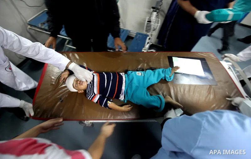 Palestinian medics wheel a wounded girl into the al-Shifa hospital in Gaza City following an Israeli air strike on November 14, 2012. An Israeli strike that killed Hamas's top commander in Gaza is only "the beginning" of...