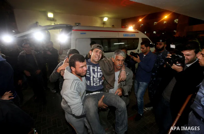 Palestinians carry a wounded man into the al-Shifa hospital in Gaza City following an Israeli air strike on November 14, 2012. An Israeli strike that killed Hamas's top commander in Gaza is only "the beginning" of an ope...