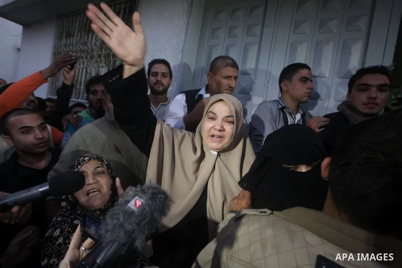 A Palestinian woman reacts at hospital after the body of Ahmed Jabari, head of the Hamas military wing, was brought, in Gaza City, Wednesday, Nov. 14, 2012. The Israeli military said its assassination of the Hamas milita...