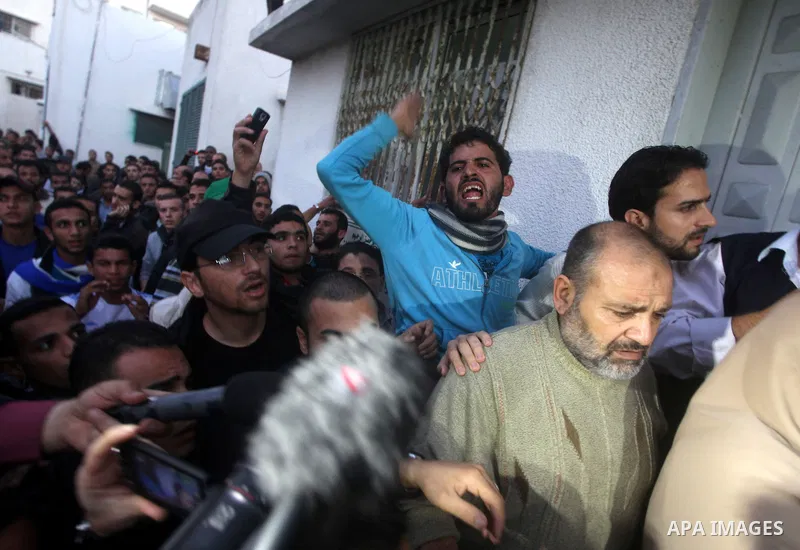 Palestinian men react at hospital after the body of Ahmed Jabari, head of the Hamas military wing, was brought, in Gaza City, Wednesday, Nov. 14, 2012. The Israeli military said its assassination of the Hamas military co...