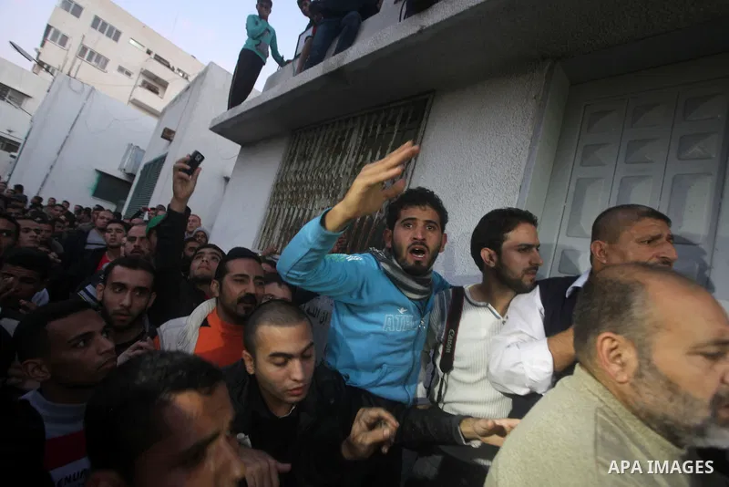 Palestinian men react at hospital after the body of Ahmed Jabari, head of the Hamas military wing, was brought, in Gaza City, Wednesday, Nov. 14, 2012. The Israeli military said its assassination of the Hamas military co...