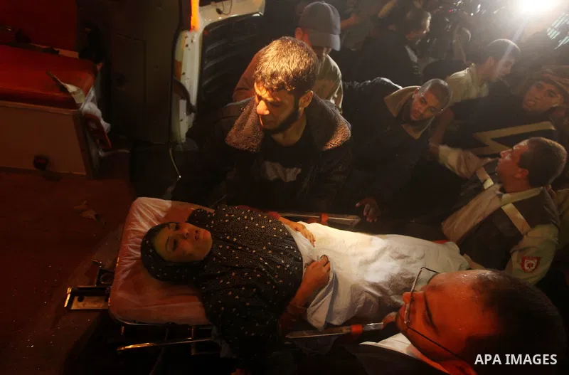 Palestinians wheel a wounded woman into a hospital after an Israeli air strike in Gaza City November 14, 2012. Israel killed the military commander of the Islamist group Hamas in a missile strike on the Gaza Strip on Wed...