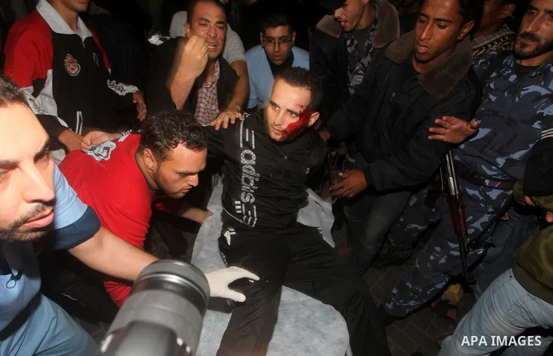 Palestinians wheel a wounded man into a hospital after an Israeli air strike in Gaza City November 14, 2012. Israel killed the military commander of the Islamist group Hamas in a missile strike on the Gaza Strip on Wedne...