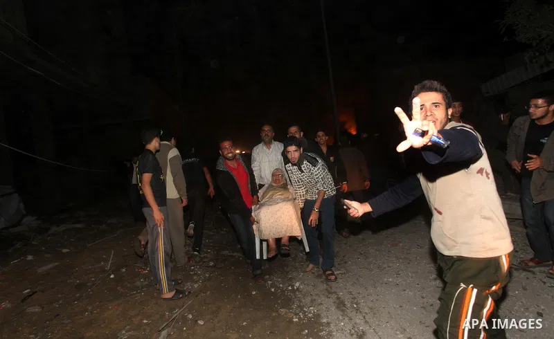 Palestinians try to extinguish fire following an Israeli air strike on November 14, 2012 in Gaza City. A top Hamas commander was among seven people killed in more than 20 Israeli air strikes on the Gaza Strip, as Israel...