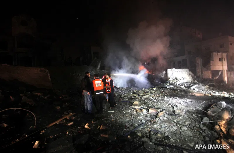 Palestinians try to extinguish fire following an Israeli air strike on November 14, 2012 in Gaza City. A top Hamas commander was among seven people killed in more than 20 Israeli air strikes on the Gaza Strip, as Israel...