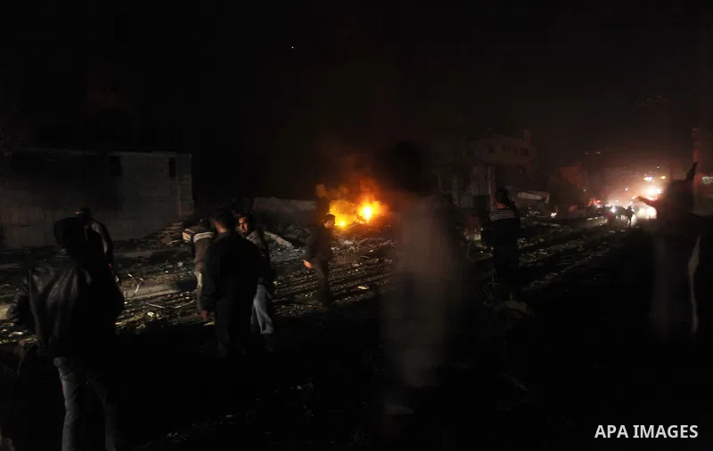 Palestinians try to extinguish fire following an Israeli air strike on November 14, 2012 in Gaza City. A top Hamas commander was among seven people killed in more than 20 Israeli air strikes on the Gaza Strip, as Israel...