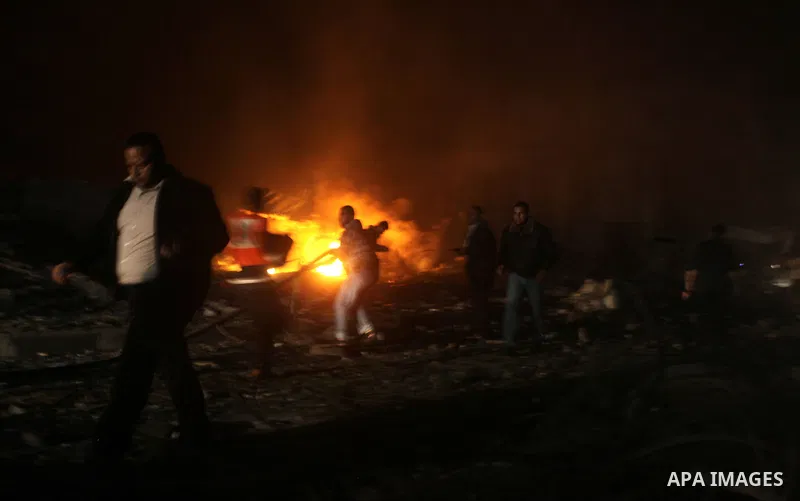 Palestinians try to extinguish fire following an Israeli air strike on November 14, 2012 in Gaza City. A top Hamas commander was among seven people killed in more than 20 Israeli air strikes on the Gaza Strip, as Israel...