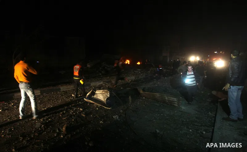 Palestinians try to extinguish fire following an Israeli air strike on November 14, 2012 in Gaza City. A top Hamas commander was among seven people killed in more than 20 Israeli air strikes on the Gaza Strip, as Israel...