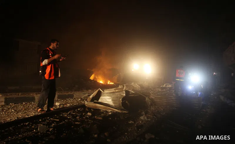 Palestinians try to extinguish fire following an Israeli air strike on November 14, 2012 in Gaza City. A top Hamas commander was among seven people killed in more than 20 Israeli air strikes on the Gaza Strip, as Israel...