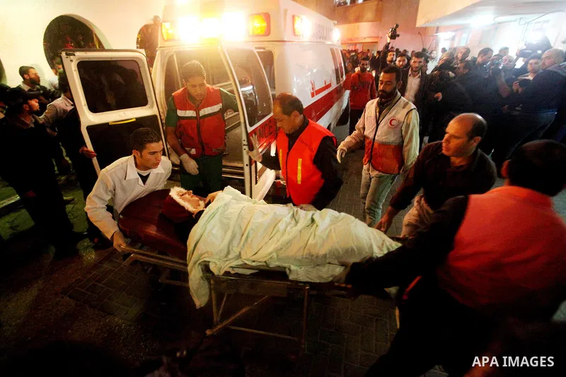Palestinians wheel a wounded woman into the treatment room of al-Shifa hospital following an Israeli airstrike in Gaza City, Wednesday, Nov. 14, 2012. The Israeli military said its assassination of the Hamas military com...