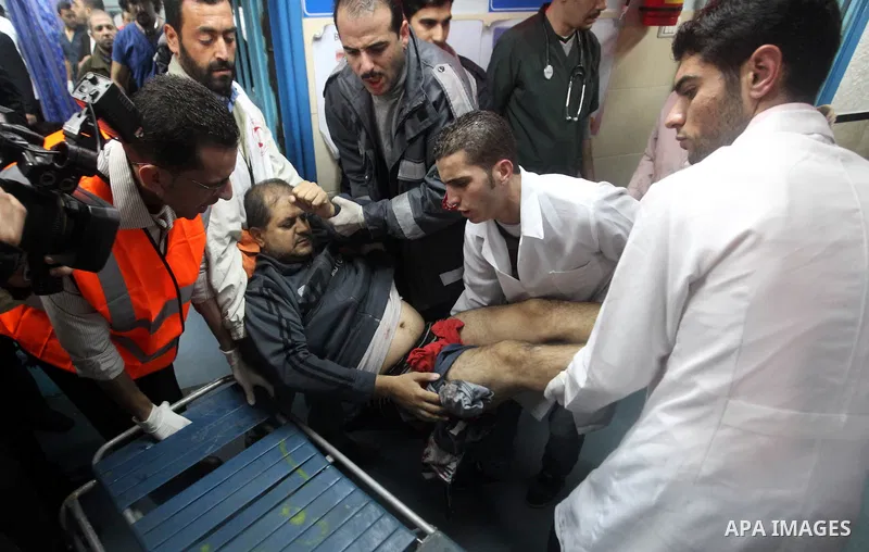 Palestinians wheel a wounded man into the treatment room of al-Shifa hospital following an Israeli airstrike in Gaza City, Wednesday, Nov. 14, 2012. The Israeli military said its assassination of the Hamas military comma...