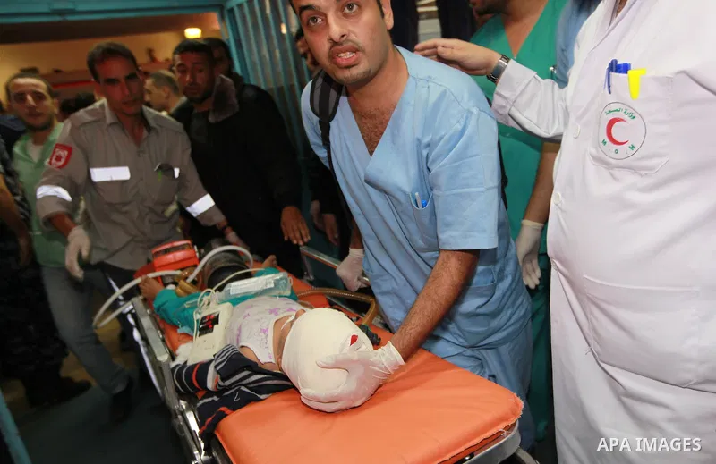 Palestinian medics wheel a wounded child into the treatment room of Shifa hospital following an Israeli airstrike in Gaza City, Wednesday, Nov. 14, 2012. The Israeli military said its assassination of the Hamas military...