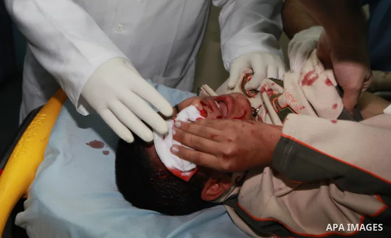 A Palestinian medic treats a wounded man into the treatment room of Shifa hospital following an Israeli airstrike in Gaza City, Wednesday, Nov. 14, 2012. The Israeli military said its assassination of the Hamas military...