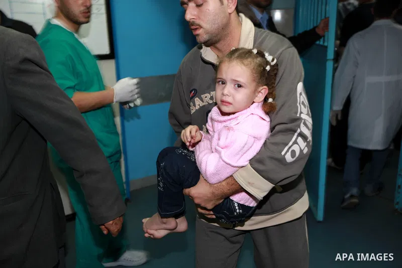 A Palestinian man carries his wounded daughter into the treatment room of Shifa hospital following an Israeli airstrike in Gaza City, Wednesday, Nov. 14, 2012. The Israeli military said its assassination of the Hamas mil...