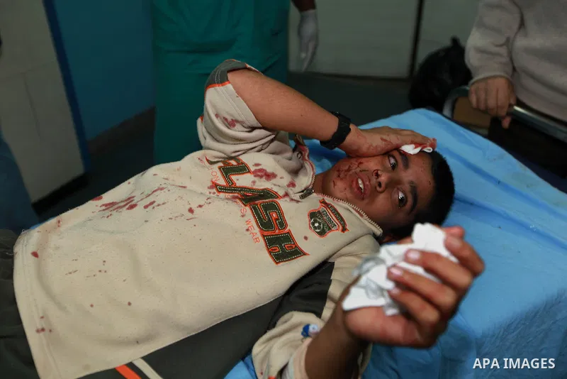A Palestinian wounded man lies on a hospital bed into the treatment room of Shifa hospital following an Israeli airstrike in Gaza City, Wednesday, Nov. 14, 2012. The Israeli military said its assassination of the Hamas m...