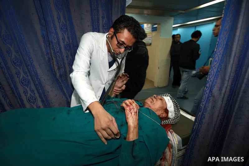 A Palestinian medic treats a wounded woman into the treatment room of Shifa hospital following an Israeli airstrike in Gaza City, Wednesday, Nov. 14, 2012. The Israeli military said its assassination of the Hamas militar...