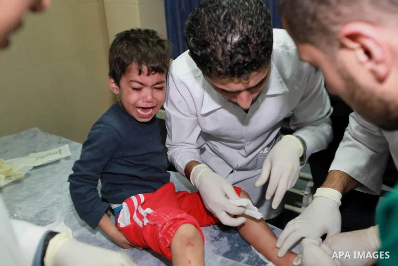 A Palestinian medic treats a wounded boy into the treatment room of Shifa hospital following an Israeli airstrike in Gaza City, Wednesday, Nov. 14, 2012. The Israeli military said its assassination of the Hamas military...
