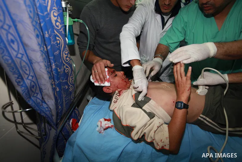 Palestinian medics treat a wounded man into the treatment room of Shifa hospital following an Israeli airstrike in Gaza City, Wednesday, Nov. 14, 2012. The Israeli military said its assassination of the Hamas military co...