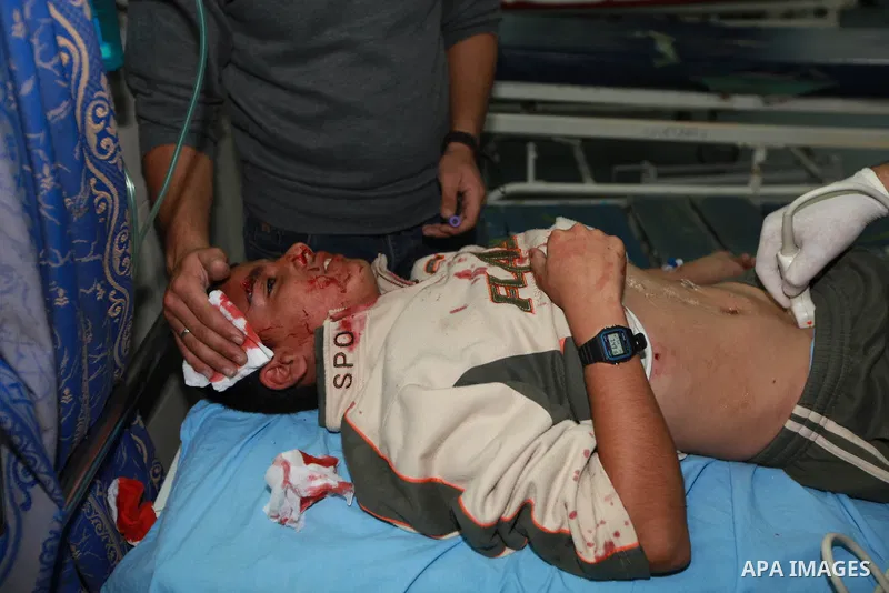 Palestinian medics treat a wounded man into the treatment room of Shifa hospital following an Israeli airstrike in Gaza City, Wednesday, Nov. 14, 2012. The Israeli military said its assassination of the Hamas military co...