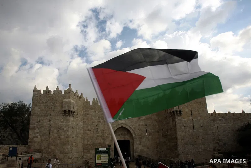 Palestinian protesters hold pictures of late Palestinian leader Yasser Arafat during a demonstration in support of the Palestinian statehood petition at the U.N. General Assembly near the Damascus gate in Jerusalem's Old...