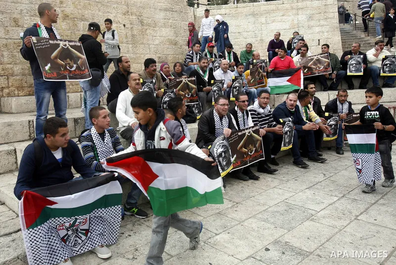 Palestinian protesters hold pictures of late Palestinian leader Yasser Arafat during a demonstration in support of the Palestinian statehood petition at the U.N. General Assembly near the Damascus gate in Jerusalem's Old...