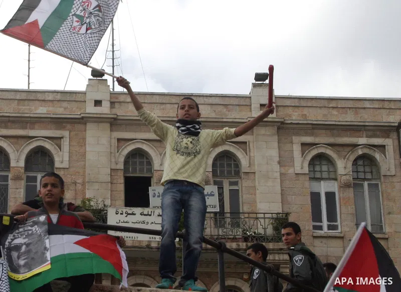 Palestinian protesters hold pictures of late Palestinian leader Yasser Arafat during a demonstration in support of the Palestinian statehood petition at the U.N. General Assembly near the Damascus gate in Jerusalem's Old...