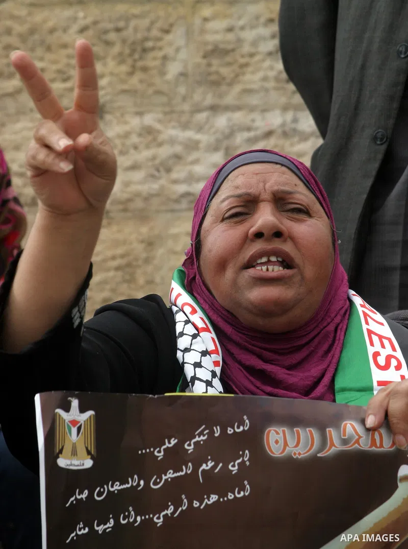 Palestinian protesters hold pictures of late Palestinian leader Yasser Arafat during a demonstration in support of the Palestinian statehood petition at the U.N. General Assembly near the Damascus gate in Jerusalem's Old...