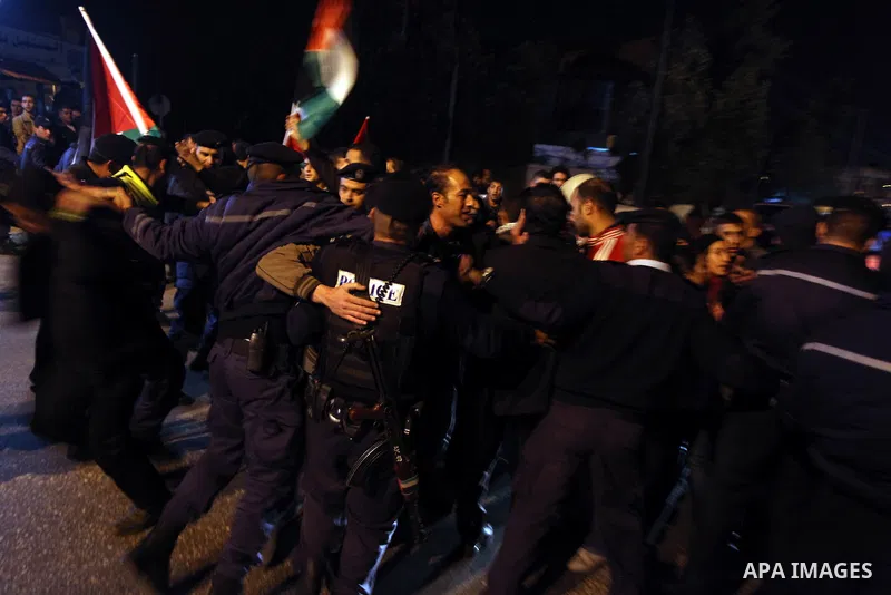 Palestinian police officers stand guard as protesters march in the West Bank city of Ramallah on November 14, 2012 during a demonstration in support of the people of the Gaza Strip and against Israeli air strikes. Severa...