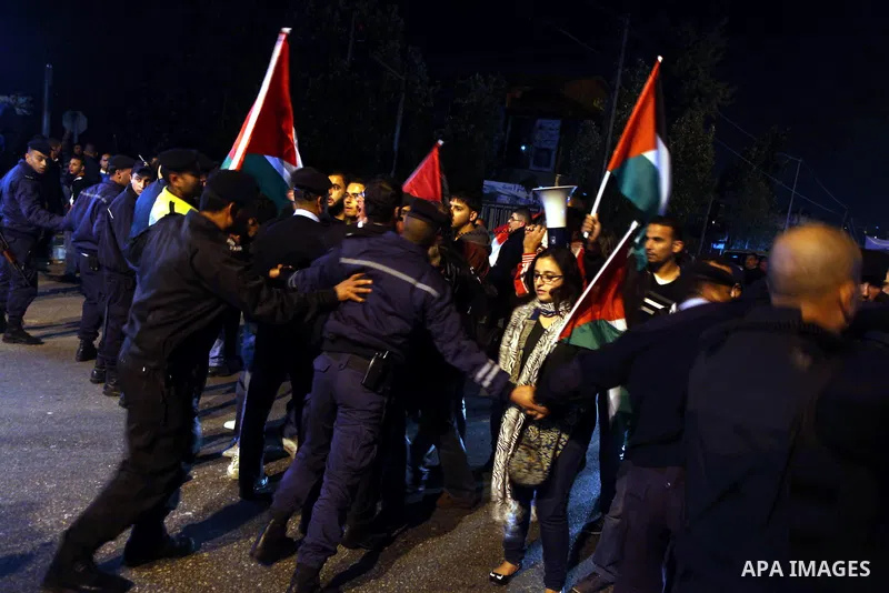 Palestinian police officers stand guard as protesters march in the West Bank city of Ramallah on November 14, 2012 during a demonstration in support of the people of the Gaza Strip and against Israeli air strikes. Severa...