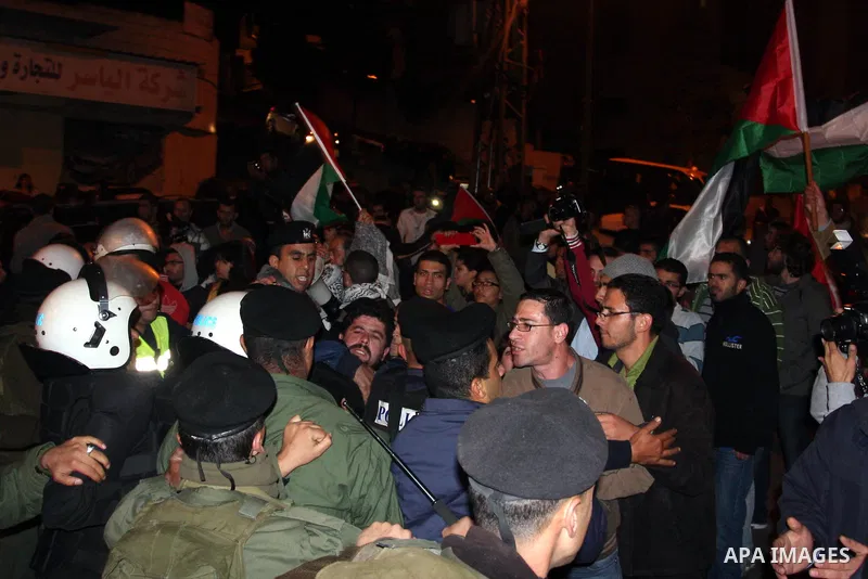 Palestinian police officers stand guard as protesters march in the West Bank city of Ramallah on November 14, 2012 during a demonstration in support of the people of the Gaza Strip and against Israeli air strikes. Severa...