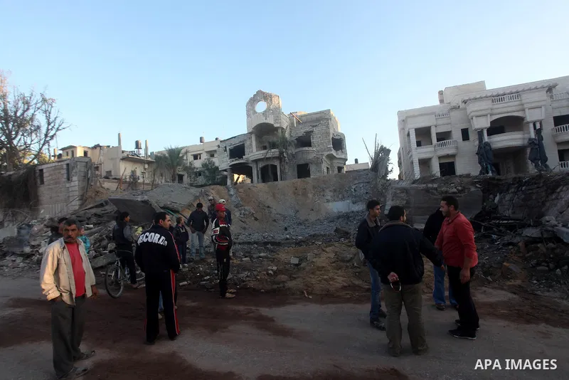 Palestinians check their damaged house after Israeli air strikes in Gaza City November 15, 2012. Israel exchanged the fiercest fire with Hamas in years after assassinating its military mastermind and threatening a wider...