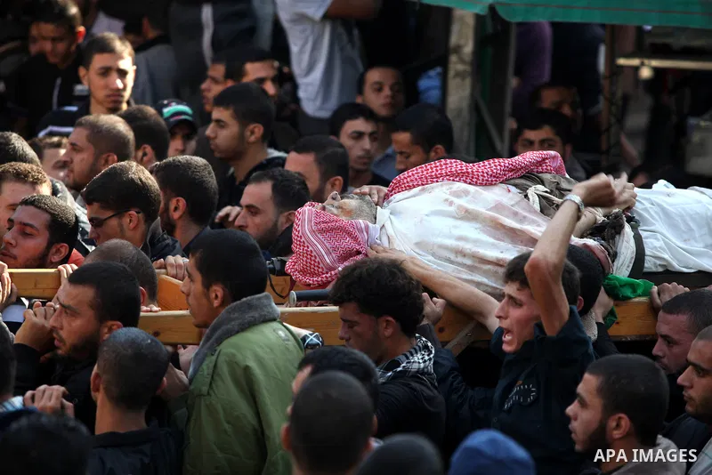 Palestinian mourners carry the body of Ahmad Jaabari, head of the military wing of the Hamas movement, the Ezzedin Qassam Brigades, during his funeral in Gaza City, on November 15, 2012. Tensions between Israel and Gaza...
