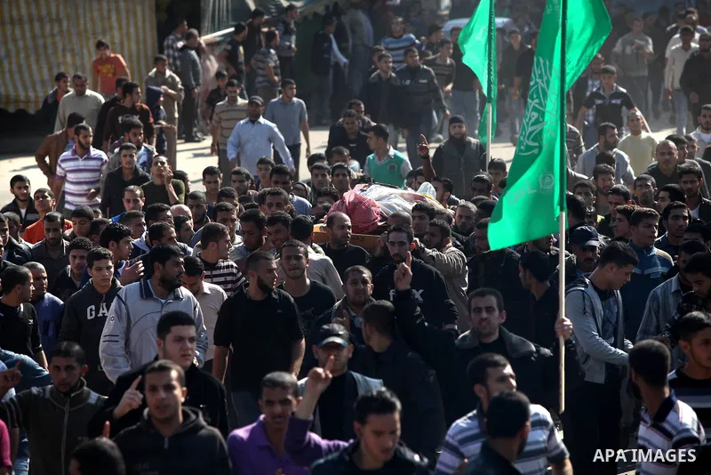 Palestinian mourners carry the body of Ahmad Jaabari, head of the military wing of the Hamas movement, the Ezzedin Qassam Brigades, during his funeral in Gaza City, on November 15, 2012. Tensions between Israel and Gaza...