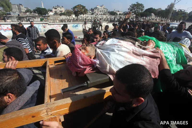 Palestinian mourners carry the body of Ahmad Jaabari, head of the military wing of the Hamas movement, the Ezzedin Qassam Brigades, during his funeral in Gaza City, on November 15, 2012. Tensions between Israel and Gaza...