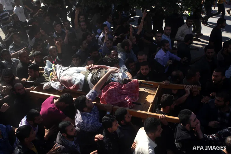 Palestinian mourners carry the body of Ahmad Jaabari, head of the military wing of the Hamas movement, the Ezzedin Qassam Brigades, during his funeral in Gaza City, on November 15, 2012. Tensions between Israel and Gaza...