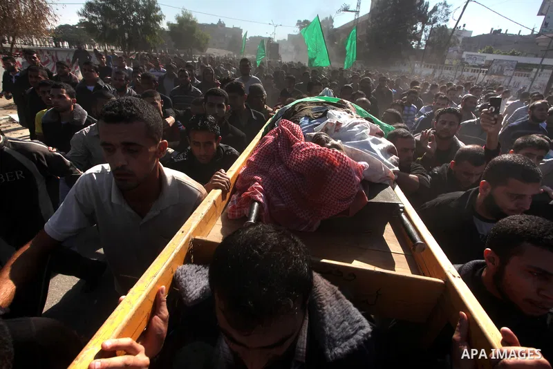 Palestinian mourners carry the body of Ahmad Jaabari, head of the military wing of the Hamas movement, the Ezzedin Qassam Brigades, during his funeral in Gaza City, on November 15, 2012. Tensions between Israel and Gaza...
