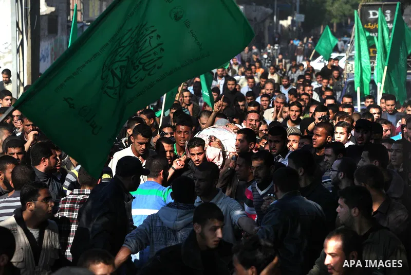 Palestinian mourners carry the body of Ahmad Jaabari, head of the military wing of the Hamas movement, the Ezzedin Qassam Brigades, during his funeral in Gaza City, on November 15, 2012. Tensions between Israel and Gaza...