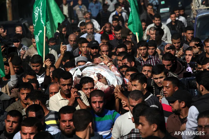 Palestinian mourners carry the body of Ahmad Jaabari, head of the military wing of the Hamas movement, the Ezzedin Qassam Brigades, during his funeral in Gaza City, on November 15, 2012. Tensions between Israel and Gaza...