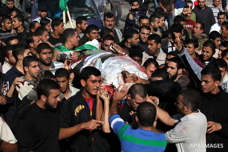 Palestinian mourners carry the body of Ahmad Jaabari, head of the military wing of the Hamas movement, the Ezzedin Qassam Brigades, during his funeral in Gaza City, on November 15, 2012. Tensions between Israel and Gaza...