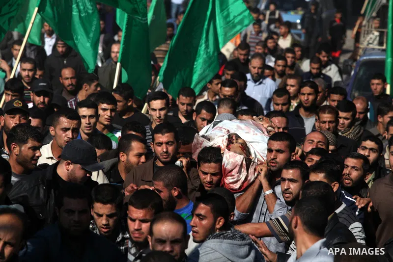 Palestinian mourners carry the body of Ahmad Jaabari, head of the military wing of the Hamas movement, the Ezzedin Qassam Brigades, during his funeral in Gaza City, on November 15, 2012. Tensions between Israel and Gaza...