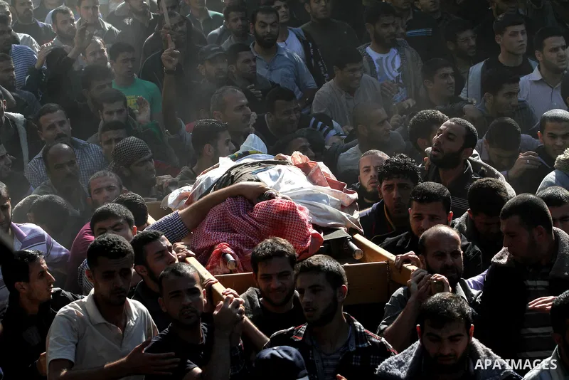 Palestinian mourners carry the body of Ahmad Jaabari, head of the military wing of the Hamas movement, the Ezzedin Qassam Brigades, during his funeral in Gaza City, on November 15, 2012. Tensions between Israel and Gaza...