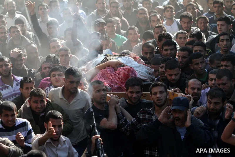 Palestinian mourners carry the body of Ahmad Jaabari, head of the military wing of the Hamas movement, the Ezzedin Qassam Brigades, during his funeral in Gaza City, on November 15, 2012. Tensions between Israel and Gaza...