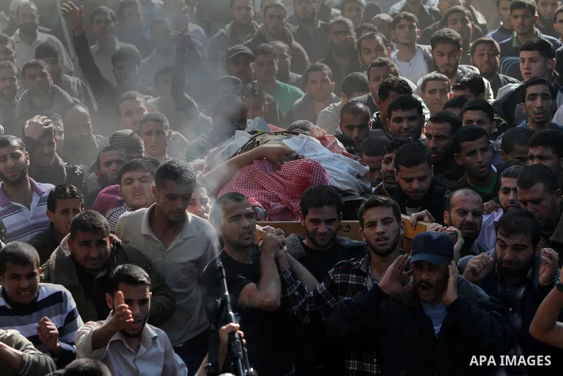 Palestinian mourners carry the body of Ahmad Jaabari, head of the military wing of the Hamas movement, the Ezzedin Qassam Brigades, during his funeral in Gaza City, on November 15, 2012. Tensions between Israel and Gaza...