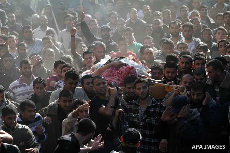Palestinian mourners carry the body of Ahmad Jaabari, head of the military wing of the Hamas movement, the Ezzedin Qassam Brigades, during his funeral in Gaza City, on November 15, 2012. Tensions between Israel and Gaza...