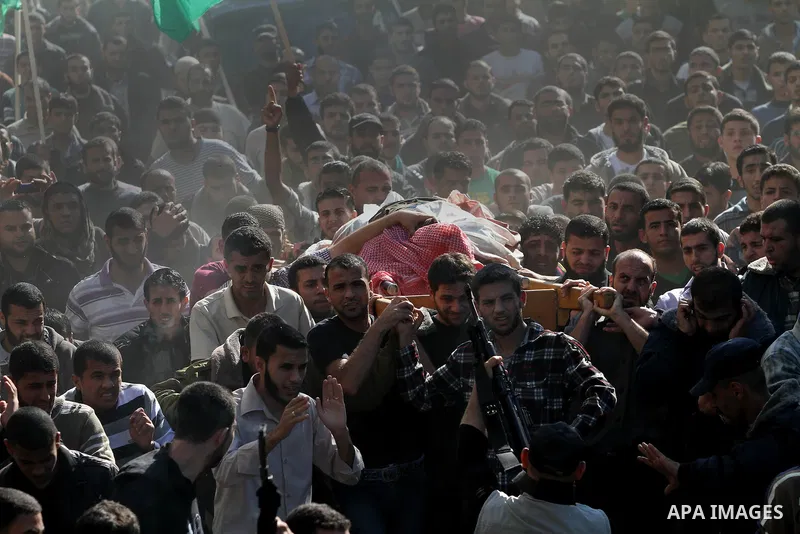 Palestinian mourners carry the body of Ahmad Jaabari, head of the military wing of the Hamas movement, the Ezzedin Qassam Brigades, during his funeral in Gaza City, on November 15, 2012. Tensions between Israel and Gaza...