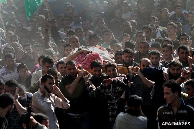 Palestinian mourners carry the body of Ahmad Jaabari, head of the military wing of the Hamas movement, the Ezzedin Qassam Brigades, during his funeral in Gaza City, on November 15, 2012. Tensions between Israel and Gaza...
