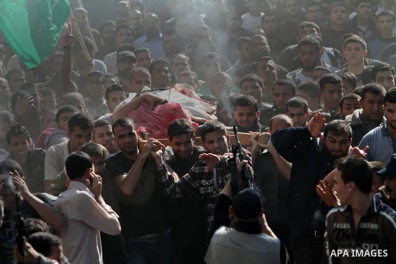 Palestinian mourners carry the body of Ahmad Jaabari, head of the military wing of the Hamas movement, the Ezzedin Qassam Brigades, during his funeral in Gaza City, on November 15, 2012. Tensions between Israel and Gaza...