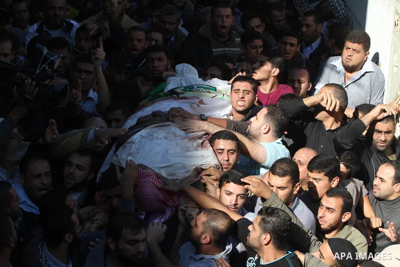 Palestinian mourners carry the body of Ahmad Jaabari, head of the military wing of the Hamas movement, the Ezzedin Qassam Brigades, during his funeral in Gaza City, on November 15, 2012. Tensions between Israel and Gaza...
